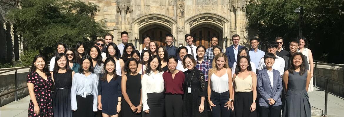 Y-VISP students lined up outside of Sterling Library wearing their Opening Ceremony clothes